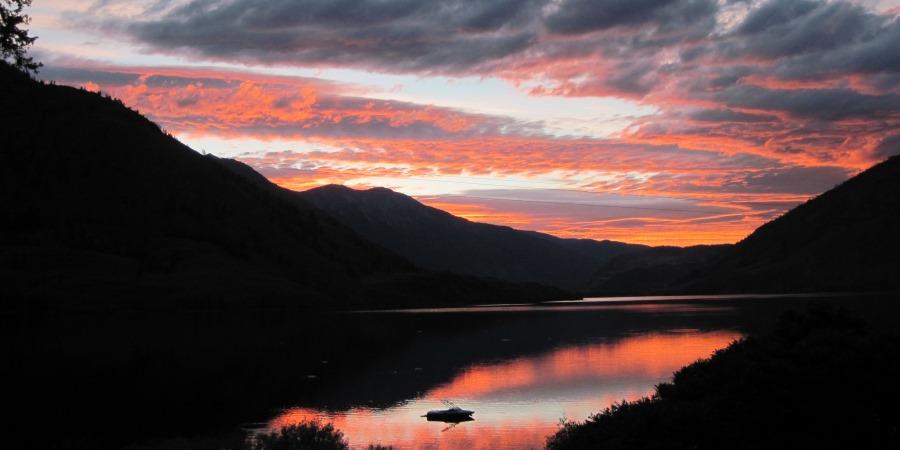 Sunset with a ski boat at the Lodge at Palmer Lake